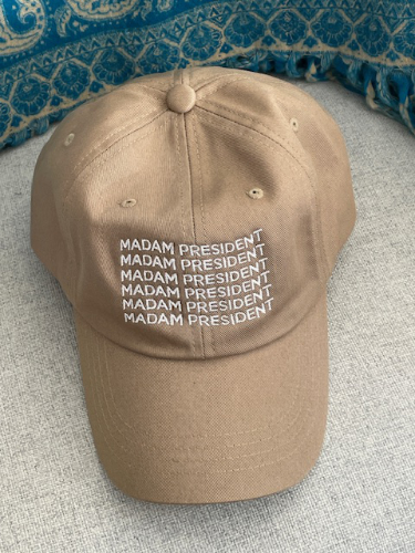 A baseball cap that says 'Madam President'