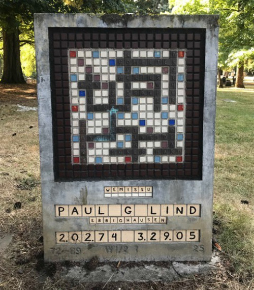 The headstone is for
a man named Paul G. Lind, and looks like a start-of-game Scrabble board, along with tile racks that spell out his name
and details.