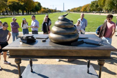 A bronze desk, with the Washington Monument in the
background, and a very visible quantity of feces on the desk