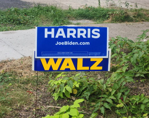 The bottom half of 
a Biden-Harris sign has been taped on top of a sign from Tim Walz' gubernatorial campaign