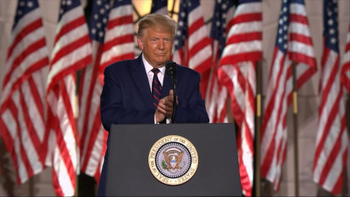 Trump, a podium in front of him,
a bunch of flags behind him, outside the White House