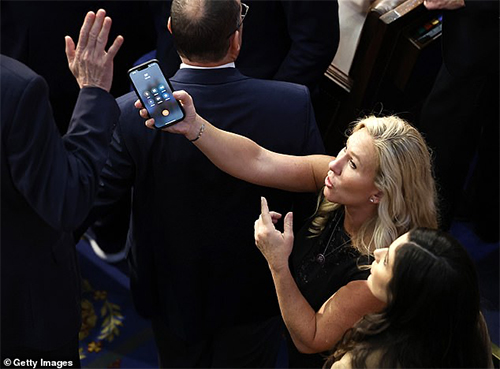 Marjorie Taylor Greene giving cell phone to Matt Rosendale