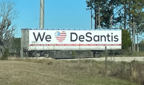 A semi-truck trailer that
has 'We love DeSantis' painted on the side