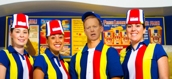 Four Hot Dog on a Stick employees,
with Sean Spicer's face pasted on top of one of their heads.