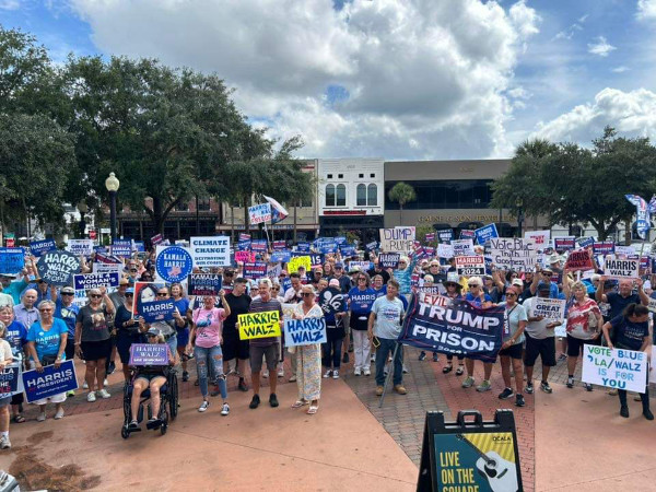 A large crowd of Harris supporters with lots of signs