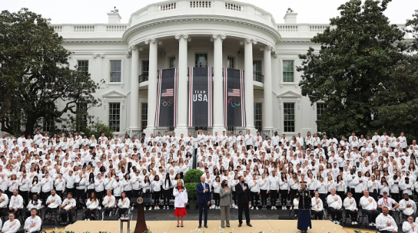 About 600 athletes, in white
uniforms, with the president, VP, and their spouses front and center.