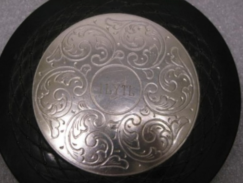 A silver compact with
fancy engraving that says ILYTG